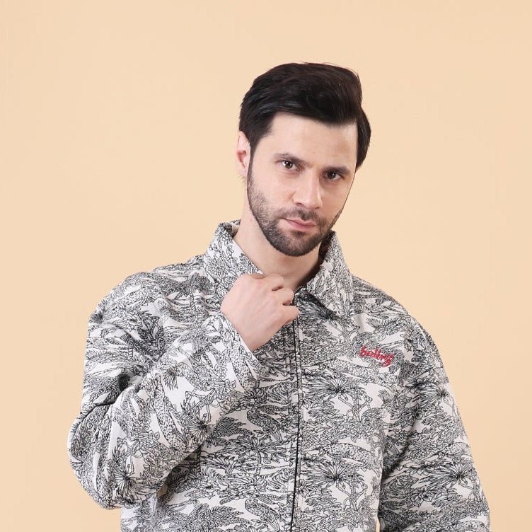 Man wearing a camouflage jacket and blue pants on a beige background