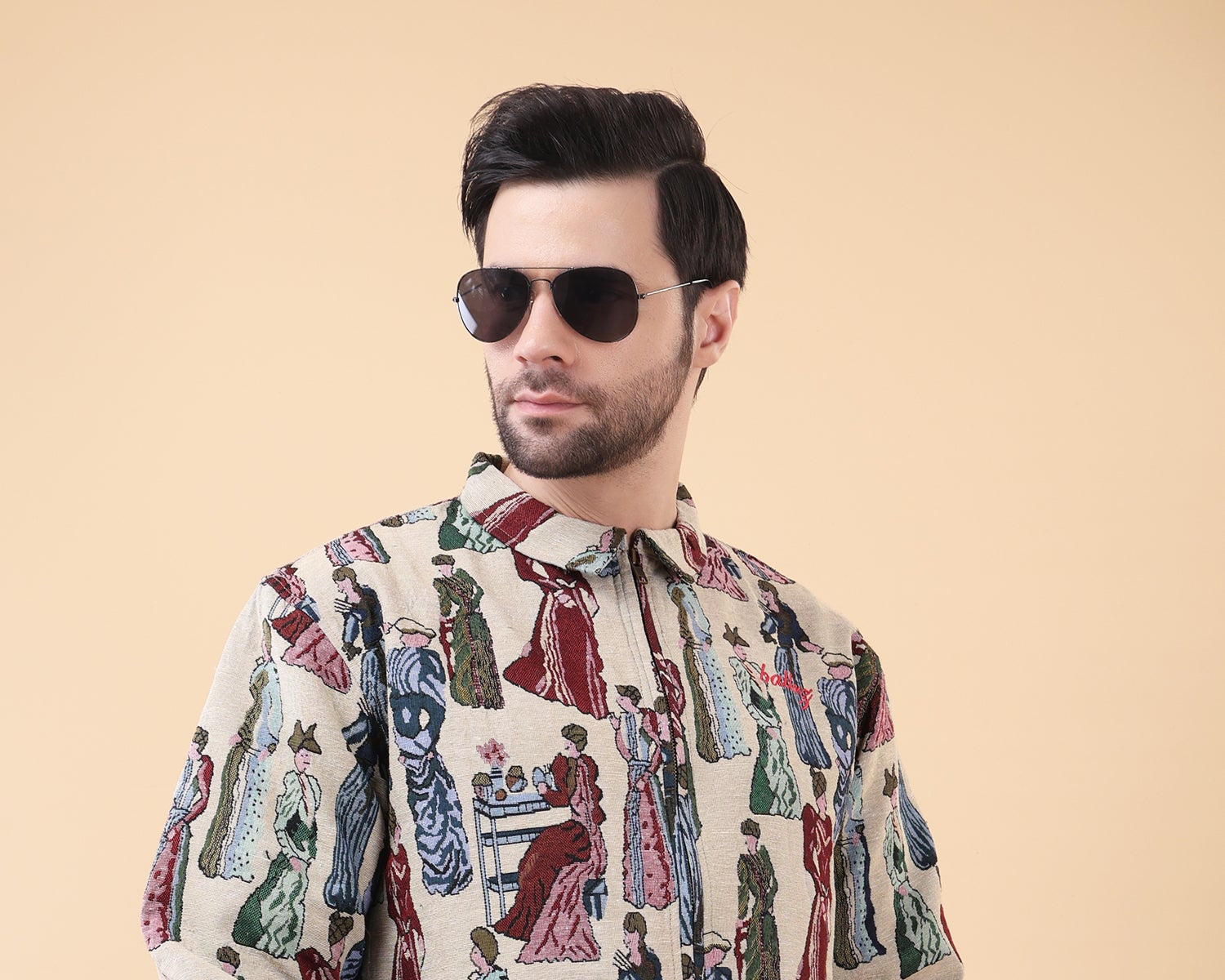 Man wearing a patterned shirt with a beige background